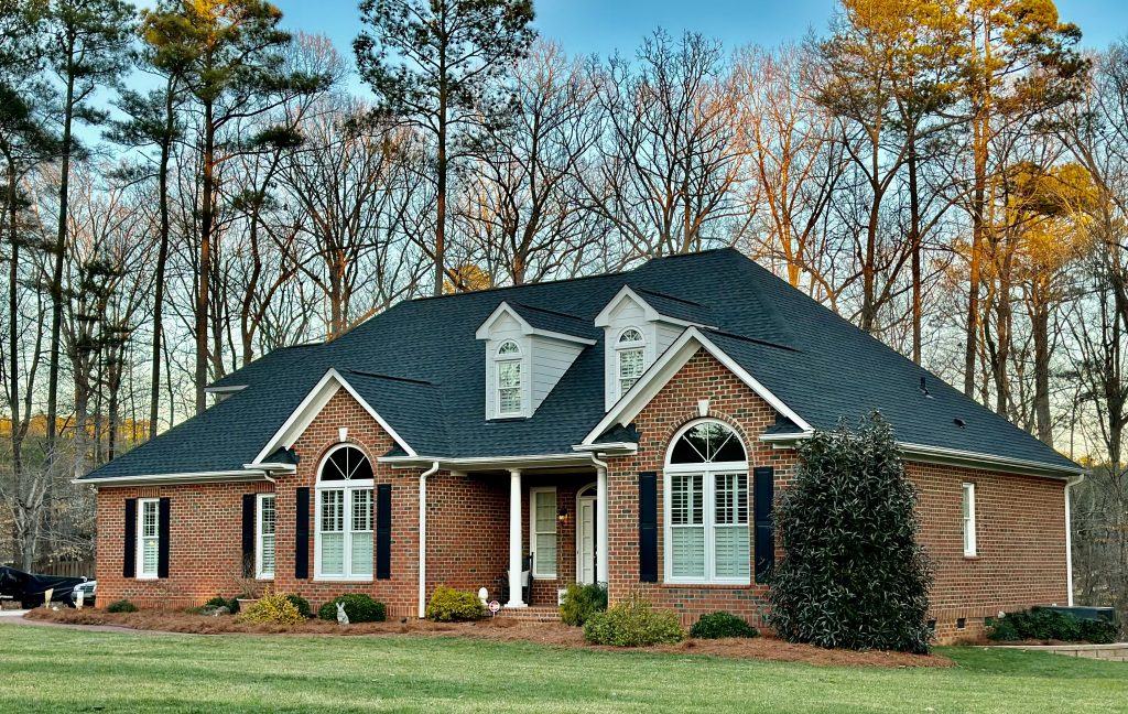 IMG_0447 Large brick home with a covered front porch and newly installed dark shingle roof in Myrtle Beach, SC