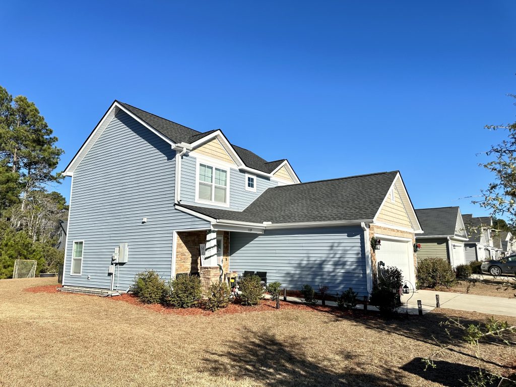 IMG_9140 Two-story gray-blue home with a new dark shingle roof in Myrtle Beach, SC