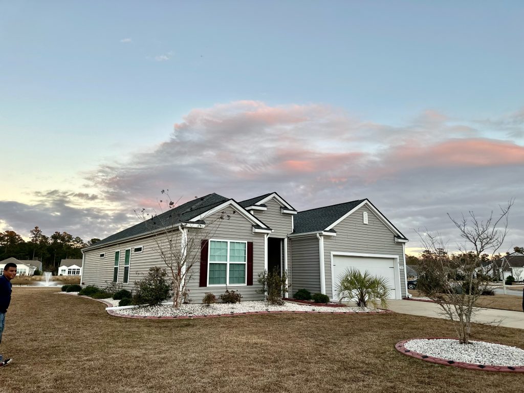 IMG_9158 Single-story home with a new shingle roof photographed at dusk in Myrtle Beach, SC