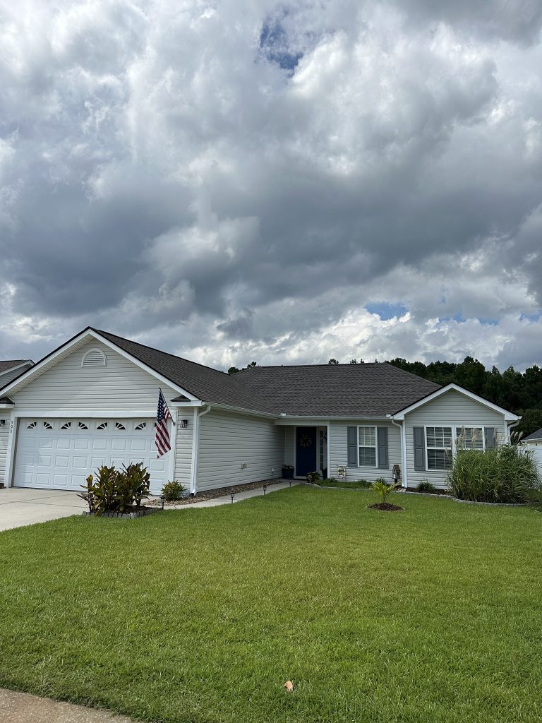 item_07bbc1a7-b6e5-4299-b406-144f29bb20da Single-story home with dark gray architectural shingle roof and two-car garage in Myrtle Beach, SC