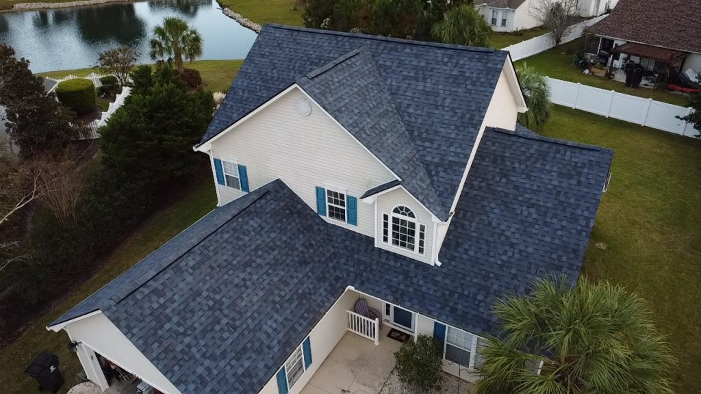 item_1801436d-b3a3-47ce-82cf-1c7d41f7faec Aerial drone view of a completed gray shingle roof replacement on a waterfront home in Myrtle Beach, SC