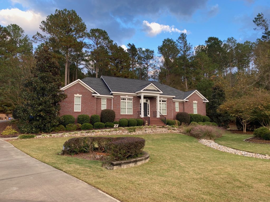 item_2078ef32-0a94-41b5-b68b-9cd8170f6ef0 Two-story home with white trim and a newly installed dark shingle roof in Savannah, GA