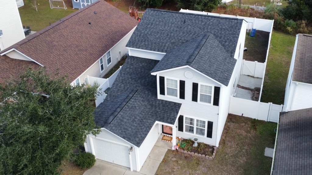 item_3ab1e9e8-ab36-463f-9c4d-dbfc18bb98e8 Aerial drone view of a completed shingle roof replacement surrounded by trees in Myrtle Beach, SC