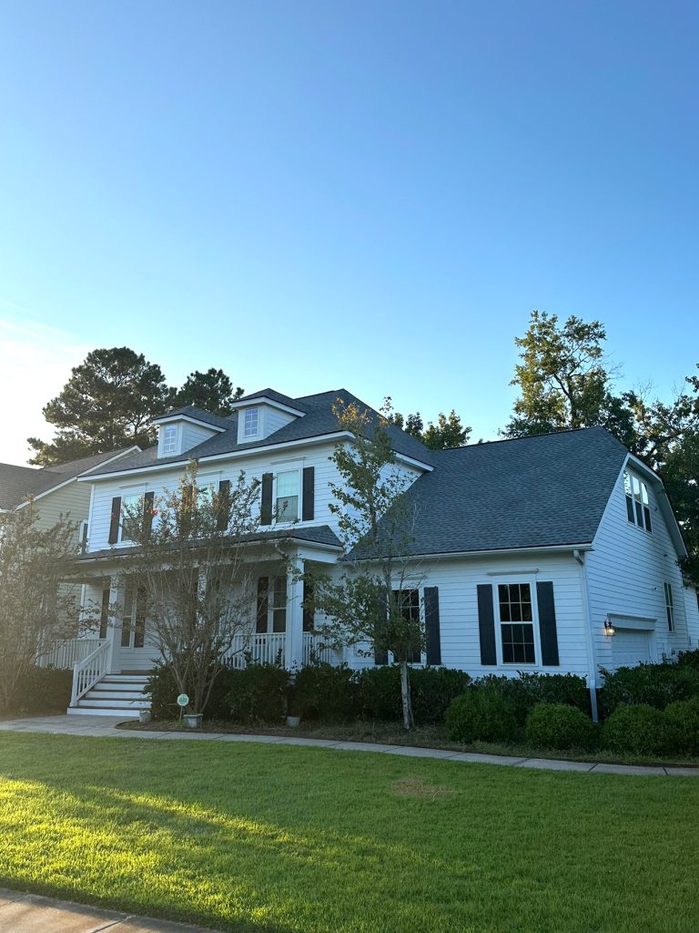 Large two-story home with a new dark gray shingle roof in Charleston, SC