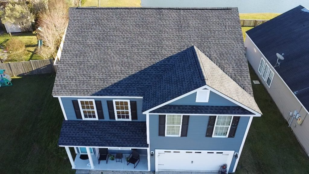 Single-story brick home with a covered porch and new shingle roof in Charleston, SC