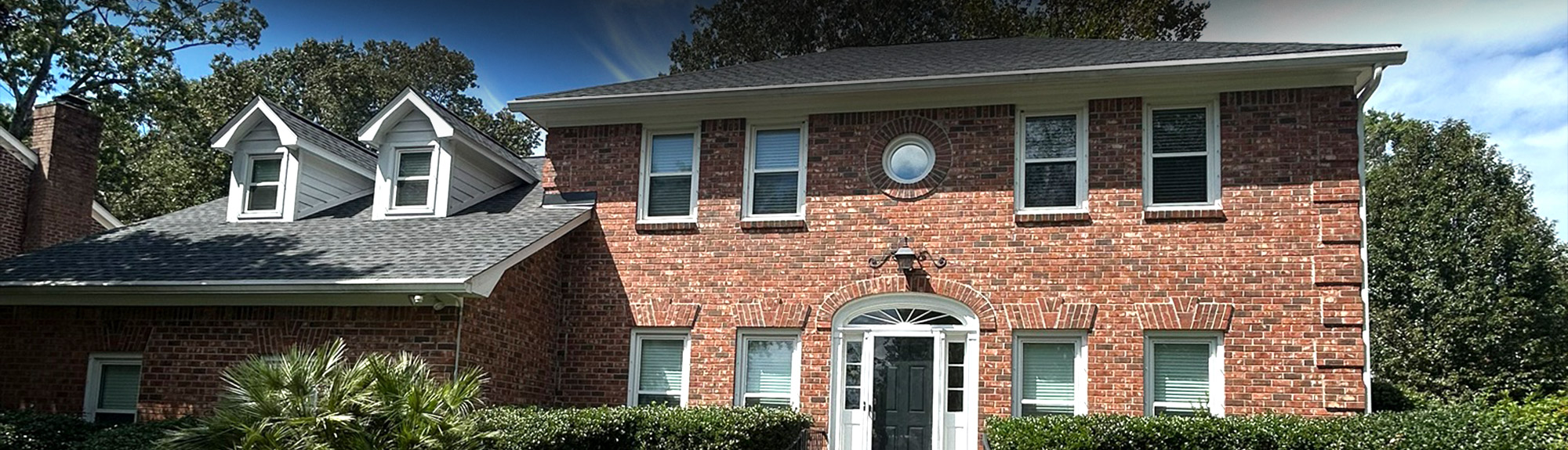 Completed asphalt shingle roof replacement on a brick home in Charleston, SC