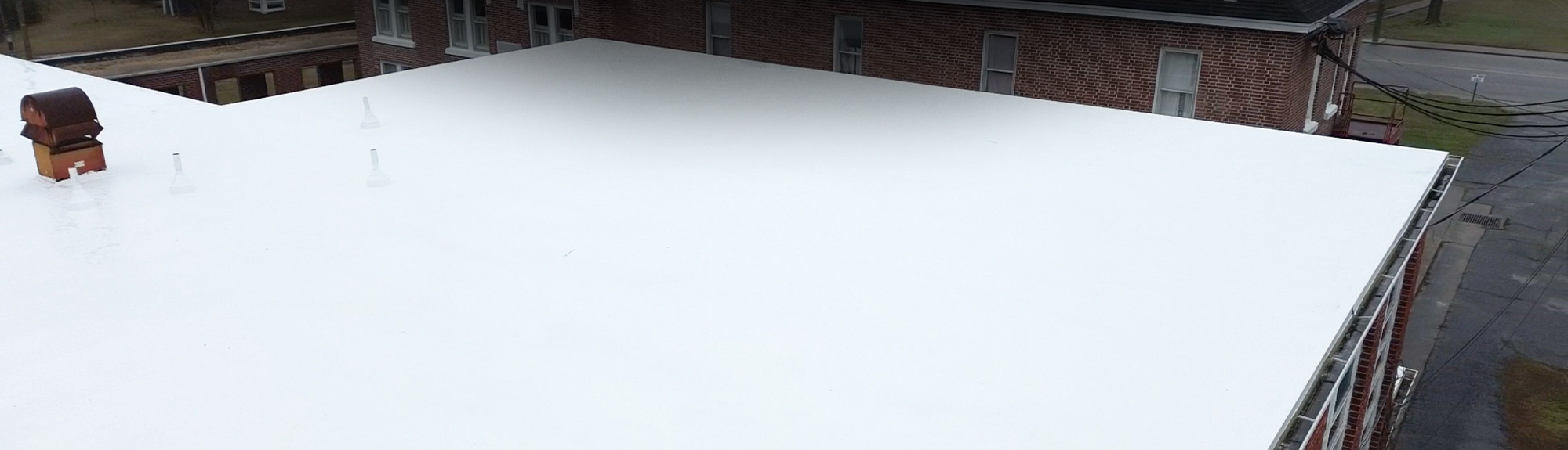 White TPO flat roof installed on a commercial building in Myrtle Beach, SC by Brazen Roofing