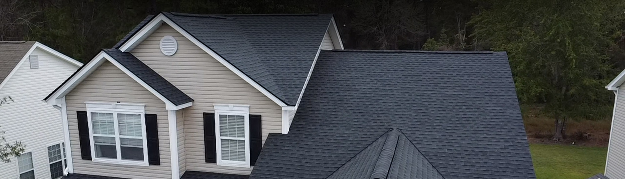 Aerial view of a completed asphalt shingle roof replacement on a home in Myrtle Beach, SC