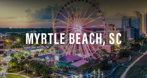 Aerial dusk view of Myrtle Beach, SC skyline and boardwalk with the SkyWheel ferris wheel