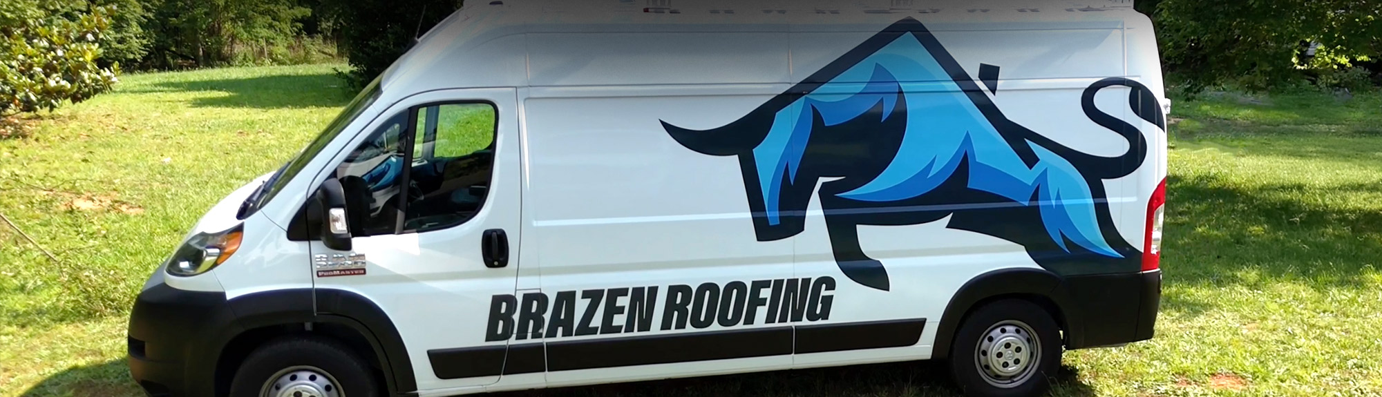 Brazen Roofing service van parked on a grassy job site in Raleigh, NC