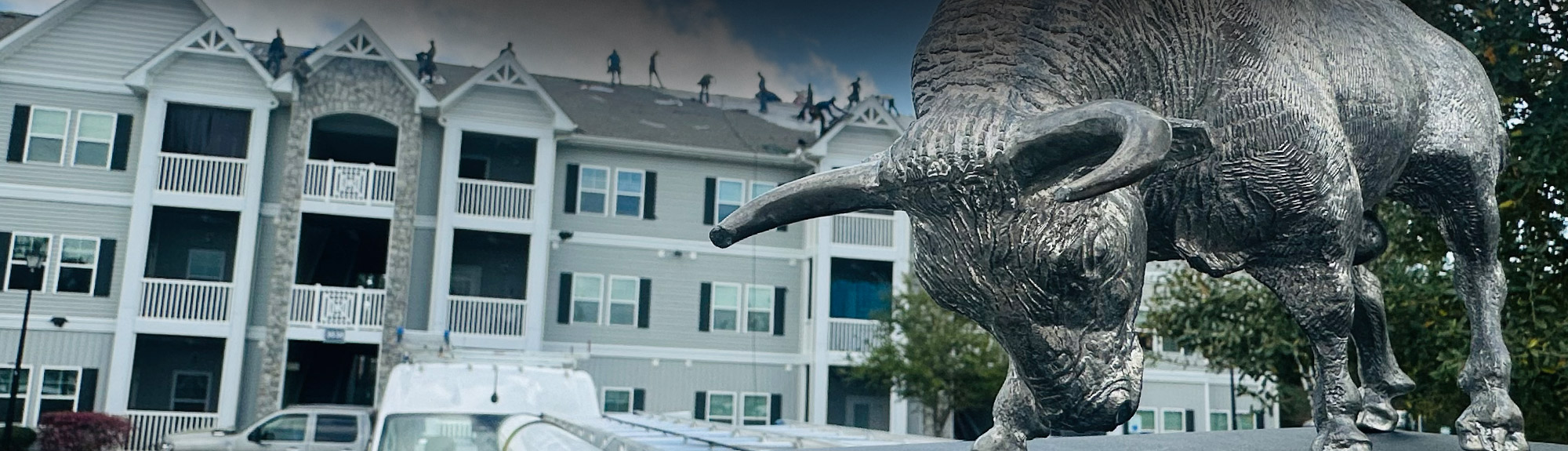 Brazen Roofing bull mascot with a roofing crew working on an apartment complex in Savannah, GA