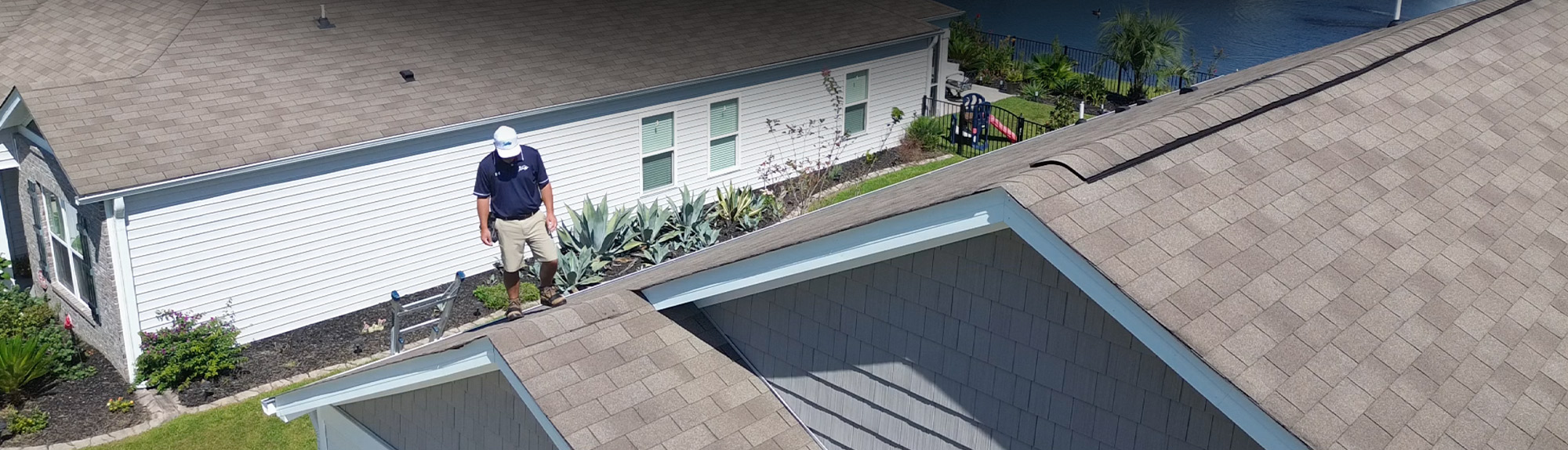 Brazen Roofing inspector examining a shingle roof during a storm damage insurance inspection