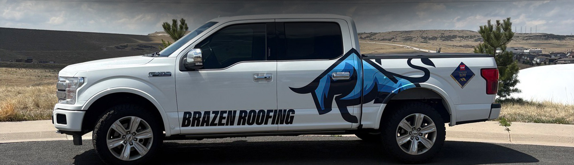 Brazen Roofing truck parked in front of the Colorado foothills near Denver, CO