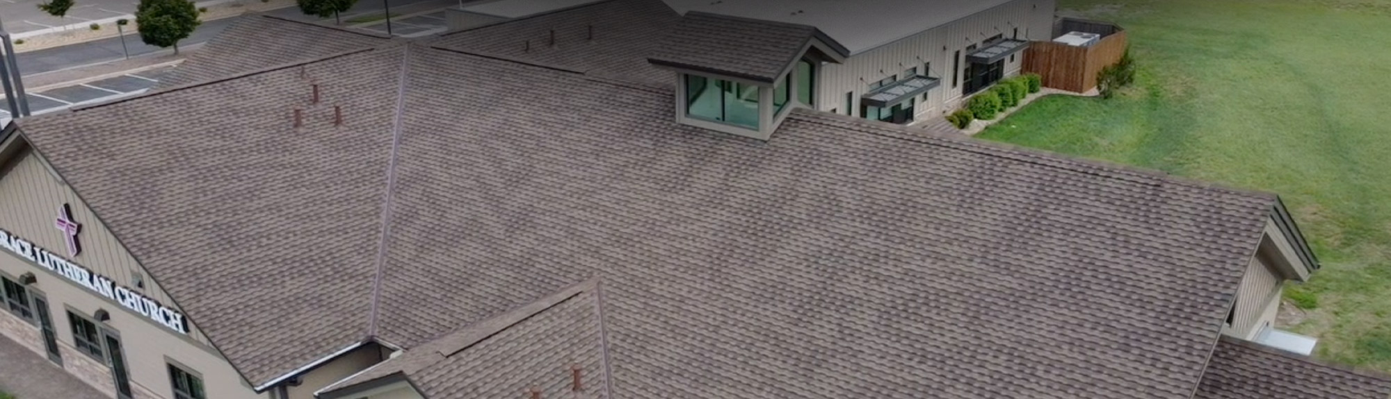 Aerial view of a Class 4 impact-resistant shingle roof installed by Brazen Roofing on a church in the Denver, CO area
