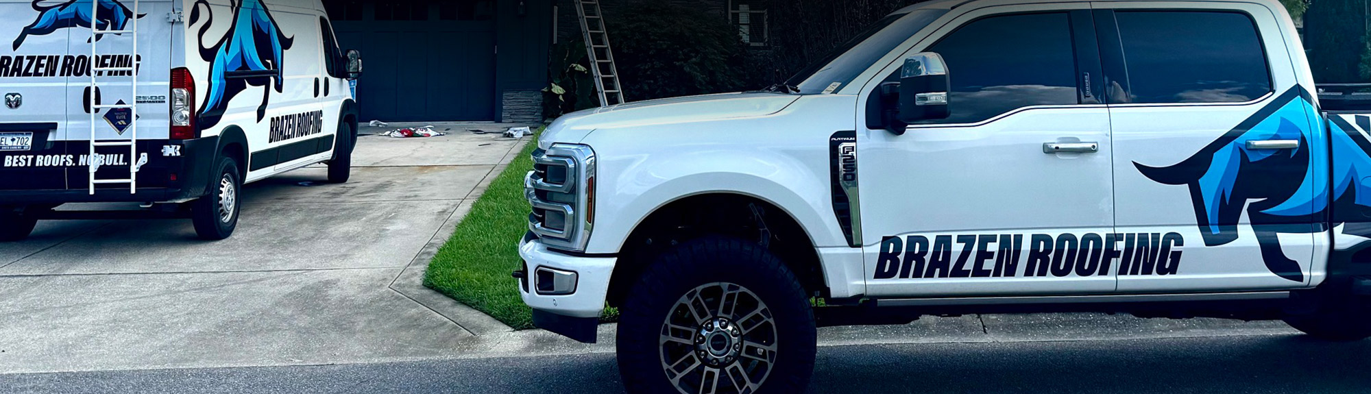 Brazen Roofing branded truck and van parked at a residential job site, the team behind roof insurance claims Knoxville homeowners trust