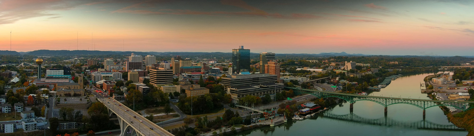 Aerial sunset view of downtown Knoxville, TN skyline and Tennessee River, part of our Knoxville roofing service area