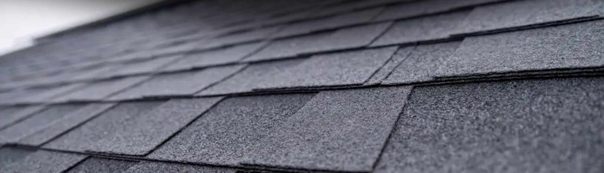 Close-up of dimensional asphalt roof shingles, the type used for impact-resistant shingles Knoxville homeowners choose