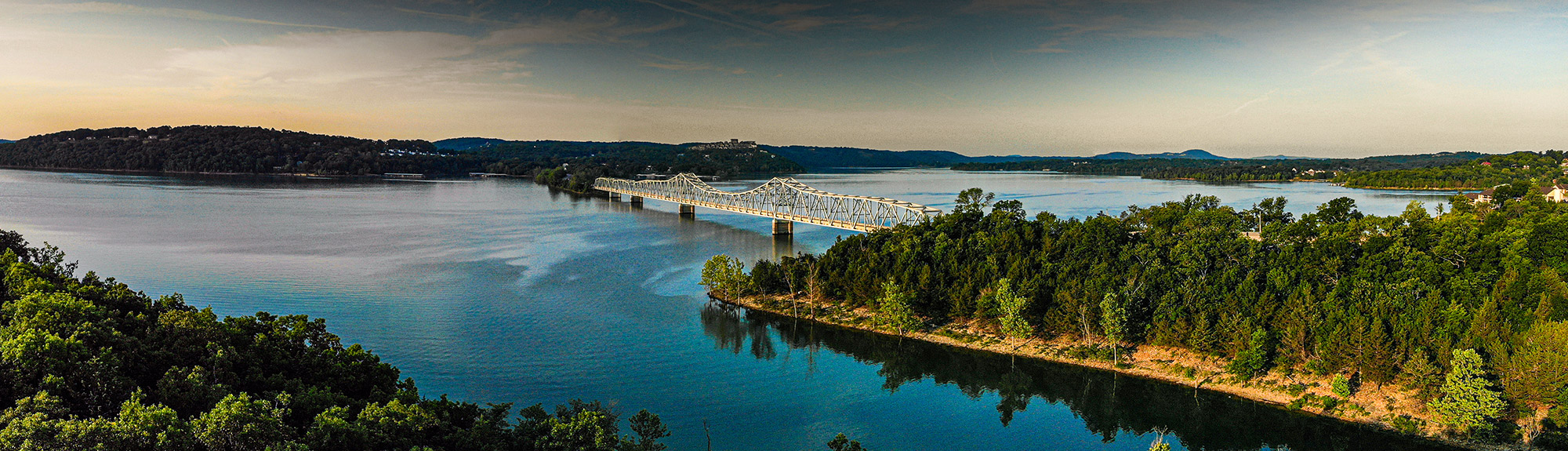 Bridge spanning a lake in the Missouri Ozarks at dusk, within the Springfield service area