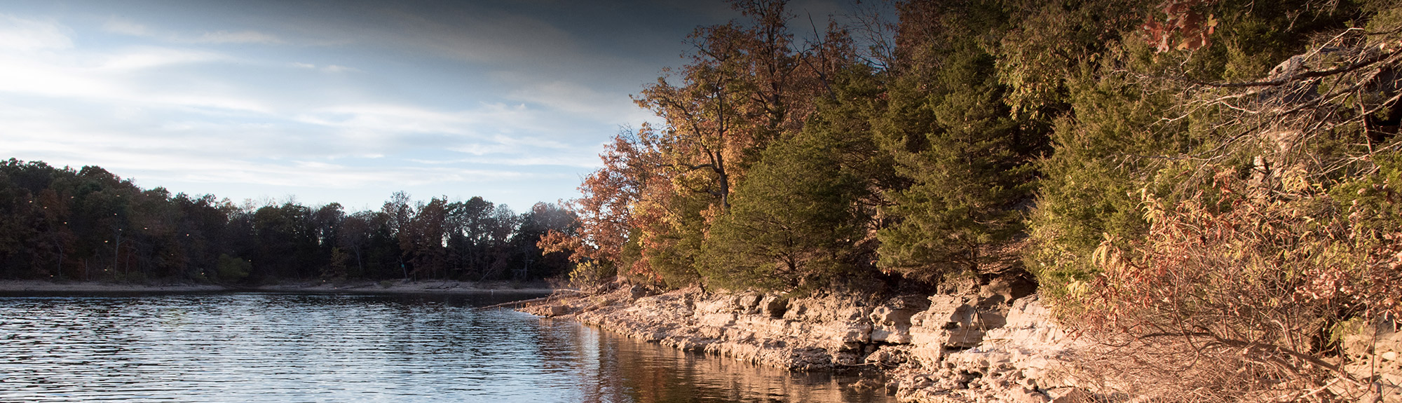 Rocky lakeshore and autumn treeline in the Missouri Ozarks near Springfield