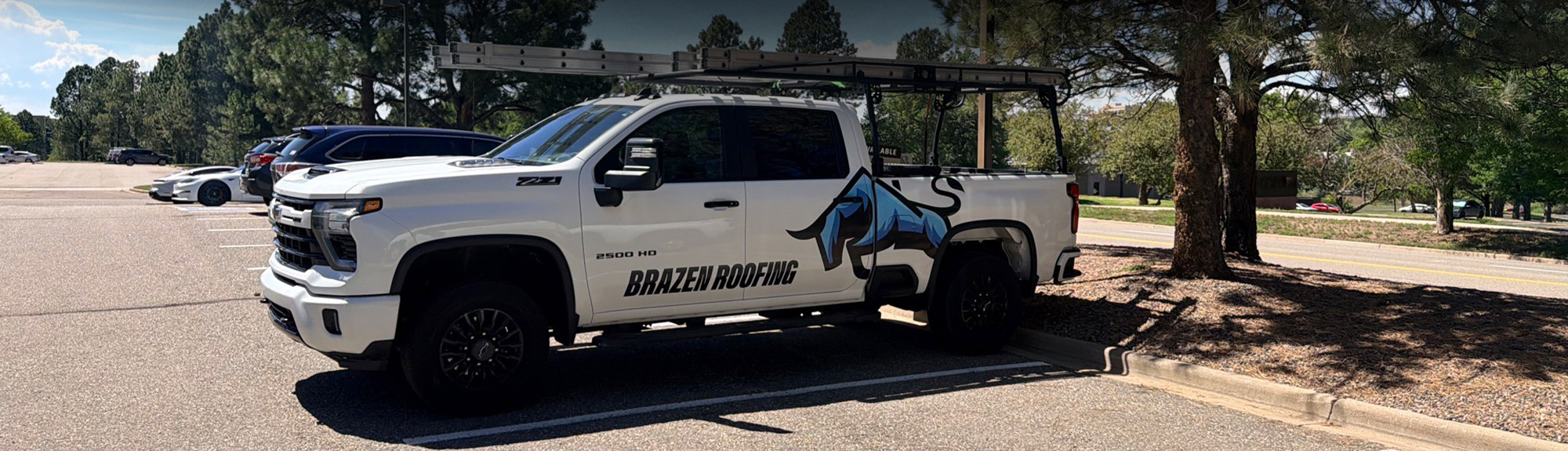 Brazen Roofing truck with ladder rack parked at a commercial job site, the team behind commercial roofing Milwaukee businesses trust