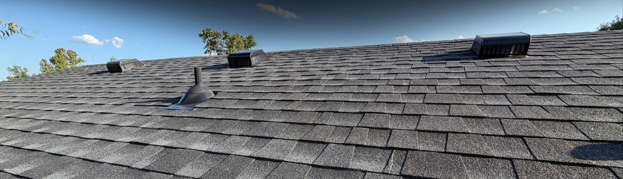 Close-up of a shingle roof with multiple roof vents installed, an example of commercial roofing Columbus businesses trust us with